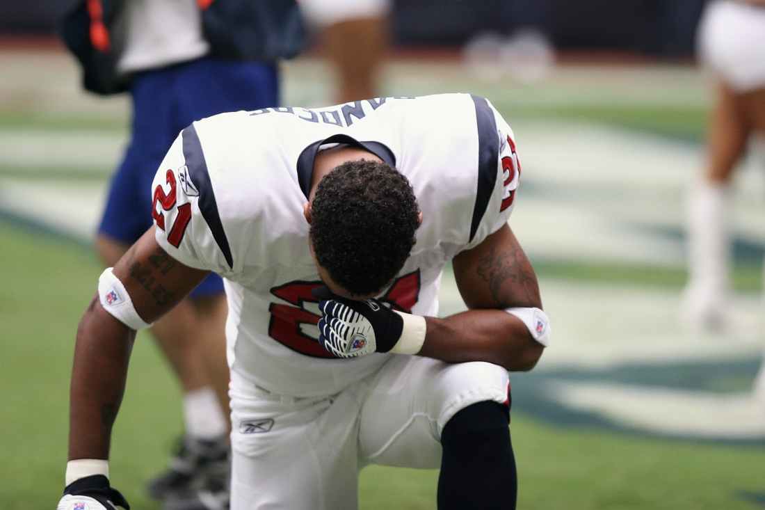 football player on bended knees